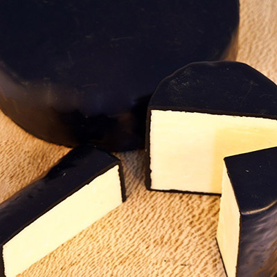 Farmhouse Black Wax Cheddar Truckle available from The Original Cheddar Cheeese Company